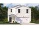 Charming two-story home featuring a covered porch, a two car garage, and crisp, white siding at 606 Quiet Valley Road, Summerville, SC 29486