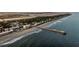 Aerial view of the coastline featuring a pier and the shoreline at 63 Mariners Cay, Folly Beach, SC 29439