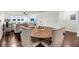 Bright and airy dining area showcasing a round table, comfortable chairs, and hardwood floors at 63 Mariners Cay, Folly Beach, SC 29439