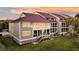 Beautiful condo exterior featuring a red roof, gray siding, and large windows at 63 Mariners Cay, Folly Beach, SC 29439