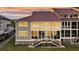 Charming exterior view of a condo with a red roof, gray siding, and stairway to the entrance at 63 Mariners Cay, Folly Beach, SC 29439