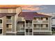 Exterior view of a modern condominium building with multiple levels and red roofing at 63 Mariners Cay, Folly Beach, SC 29439