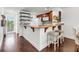 Cozy kitchen area featuring a wooden bar, white cabinets, and dark hardwood floors at 63 Mariners Cay, Folly Beach, SC 29439