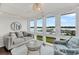 Bright living room with water views, comfortable seating, and stylish decor creating a serene and inviting living space at 63 Mariners Cay, Folly Beach, SC 29439