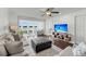Bright living room with waterfront view, comfortable seating, and modern entertainment setup for relaxation and enjoyment at 63 Mariners Cay, Folly Beach, SC 29439
