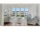 Charming living room with waterfront views, featuring cozy seating, natural light, and a serene ambiance for relaxation at 63 Mariners Cay, Folly Beach, SC 29439