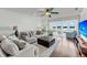 Inviting living room featuring comfortable seating, hardwood floors, and large windows at 63 Mariners Cay, Folly Beach, SC 29439