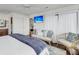 Spacious bedroom with hardwood floors, comfortable seating, and abundant natural light, creating a peaceful retreat at 63 Mariners Cay, Folly Beach, SC 29439