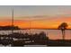 Tranquil waterfront view at sunset featuring a picturesque harbor with docked boats, creating a serene ambiance at 63 Mariners Cay, Folly Beach, SC 29439