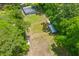 Aerial view highlights the spacious, well-maintained lot featuring grassy areas and accessory buildings at 7239 Commodore Rd, Hollywood, SC 29449