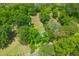 An aerial view shows the property surrounded by lush greenery and mature trees at 7239 Commodore Rd, Hollywood, SC 29449