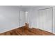 Spacious bedroom with hardwood floors, closet, and doorways, offering a versatile and stylish living space at 7239 Commodore Rd, Hollywood, SC 29449