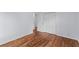Bedroom with hardwood floors, a closet, and a view to a second room, offering functionality and style at 7239 Commodore Rd, Hollywood, SC 29449