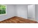 Bedroom with hardwood floors and a window providing natural light, creating a simple and bright atmosphere at 7239 Commodore Rd, Hollywood, SC 29449