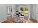 Charming dining area with white table, chairs, and backyard views at 7239 Commodore Rd, Hollywood, SC 29449