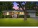 Charming brick home features a manicured lawn, a side garage, and a tree shading the front yard at 7239 Commodore Rd, Hollywood, SC 29449