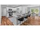 Modern eat-in kitchen features white cabinets, stainless appliances and granite countertops, perfect for cooking and entertaining at 7239 Commodore Rd, Hollywood, SC 29449