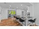 Bright open eat-in kitchen has white cabinets, stainless appliances, granite countertops and breakfast bar with seating at 7239 Commodore Rd, Hollywood, SC 29449