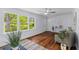 Bright living room featuring large windows with backyard views and modern decor at 7239 Commodore Rd, Hollywood, SC 29449