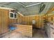 Functional outbuilding interior, equipped with fan, window and stall at 7239 Commodore Rd, Hollywood, SC 29449