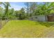Backyard with mature trees, green grass and a fence at 7239 Commodore Rd, Hollywood, SC 29449