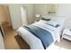 Bright bedroom features light hardwood floors, a comfortable bed, and soft natural light at 7423 Indigo Palms Way, Johns Island, SC 29455
