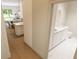 Modern bathroom with double vanity, elegant mirrors, and a view into the open-concept living space at 7622 Indigo Palms Way, Johns Island, SC 29455
