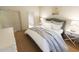 Bedroom with plush bedding, side tables, and closet, with a glimpse of an ensuite bathroom at 7622 Indigo Palms Way, Johns Island, SC 29455