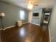 Bedroom with hardwood floors, mini fridge, ceiling fan, and mounted TV provides a tranquil living space at 8254 Timberidge Ct, North Charleston, SC 29420