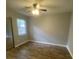 This cozy bedroom offers wood-look floors, a ceiling fan, and bright, natural light at 8254 Timberidge Ct, North Charleston, SC 29420