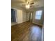 This cozy bedroom offers wood-look floors, a ceiling fan, and closet with mirror doors at 8254 Timberidge Ct, North Charleston, SC 29420