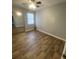 This cozy bedroom offers wood-look floors, a ceiling fan, and bright, natural light at 8254 Timberidge Ct, North Charleston, SC 29420