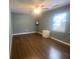 Bedroom with hardwood floors, mini fridge, and ceiling fan provides a tranquil living space at 8254 Timberidge Ct, North Charleston, SC 29420