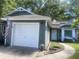 Inviting home featuring a well-maintained lawn, a white garage door, and fresh exterior paint at 8254 Timberidge Ct, North Charleston, SC 29420