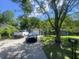 Suburban home with a spacious driveway, green lawn, and mature trees offering privacy at 8254 Timberidge Ct, North Charleston, SC 29420