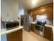 Efficient kitchen features stainless steel appliances, tile floors, and ample cabinet storage at 8254 Timberidge Ct, North Charleston, SC 29420
