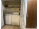 This laundry room offers a washer and dryer with storage on shelves above at 8254 Timberidge Ct, North Charleston, SC 29420