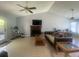 Cozy living area featuring a fireplace, ceiling fans, and tile floors with lots of natural light at 8254 Timberidge Ct, North Charleston, SC 29420
