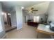 Bright open-concept living area featuring tiled flooring, a ceiling fan, and neutral wall colors at 8254 Timberidge Ct, North Charleston, SC 29420