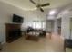 Bright living room featuring tile floors, a fireplace, high ceilings, and ceiling fans at 8254 Timberidge Ct, North Charleston, SC 29420