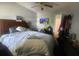 Main bedroom with an oversized bed, ceiling fan, and mounted TV provides a tranquil living space at 8254 Timberidge Ct, North Charleston, SC 29420