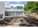 The backyard of a large multi-story home with a concrete pool being built with dirt and a wooden fence at 931 Kincade Dr, Mount Pleasant, SC 29464
