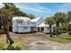 Eye-level exterior view of home with white siding, bright metal roof, and under construction landscaping at 931 Kincade Dr, Mount Pleasant, SC 29464