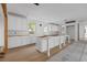 Bright, unfinished kitchen features white cabinets, wood floors, and a center island at 931 Kincade Dr, Mount Pleasant, SC 29464