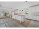 Bright kitchen features white cabinets, a center island, wood floors, and abundant natural light at 931 Kincade Dr, Mount Pleasant, SC 29464