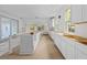 Bright, unfinished kitchen features white cabinets, wood floors, a center island and a view of outdoor scenery at 931 Kincade Dr, Mount Pleasant, SC 29464