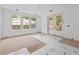 Large bright living room with three windows and glass doors, all on hardwood floors and awaiting finishing touches at 931 Kincade Dr, Mount Pleasant, SC 29464