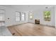 Bright living room features wood floors, a fireplace, and three large windows at 931 Kincade Dr, Mount Pleasant, SC 29464