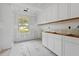 Pantry with white cabinets, shelving, hardwood floors and natural light, awaiting countertops at 931 Kincade Dr, Mount Pleasant, SC 29464