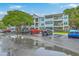 Three-story apartment building with ample parking and mature trees at 1025 Riverland Woods Pl # 904, Charleston, SC 29412